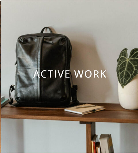 A black leather backpack on a wooden console