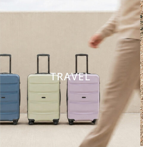 Three hard-shell suitcases in pastel colours