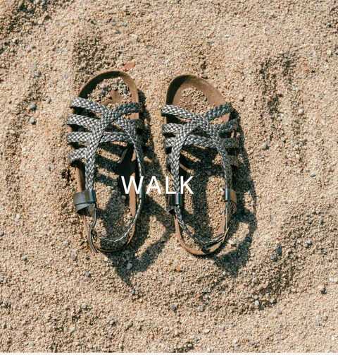 A pair of braided sandals on the sand